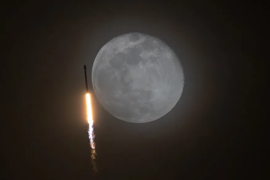 A SpaceX Falcon 9 rocket cruises by a nearly full Moon during the RRT-1 mission on Monday, Dec. 16, 2024. Image: Michael Cain/Spaceflight Now